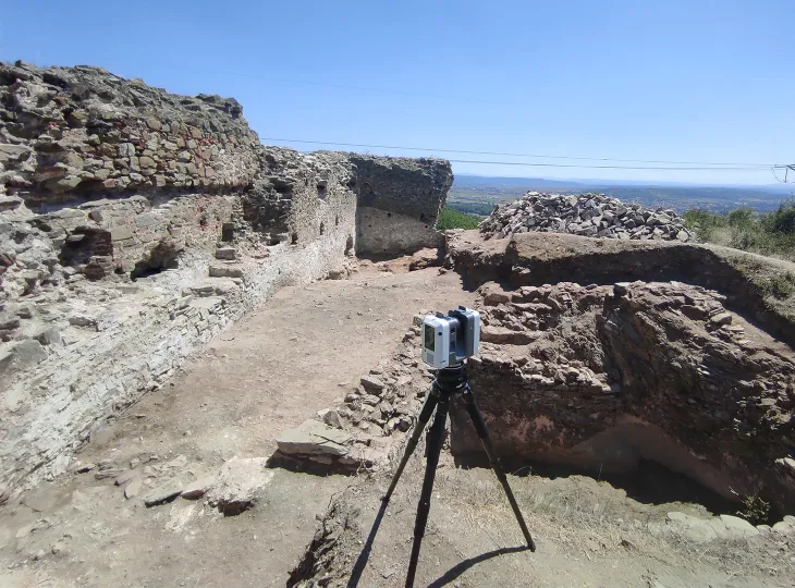 archeology site with surveying equipment in the background